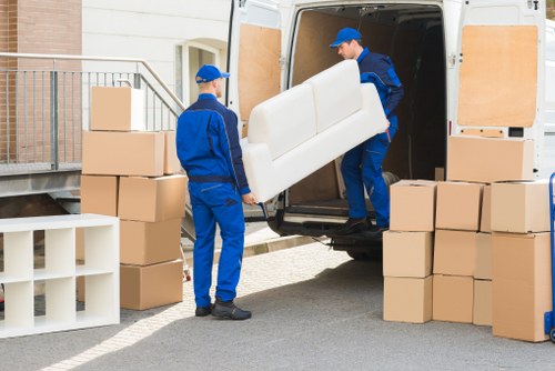 Professional movers loading furniture using a man and van service in Harringay