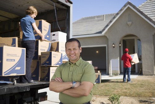 Professional movers loading boxes during an urgent Harringay relocation